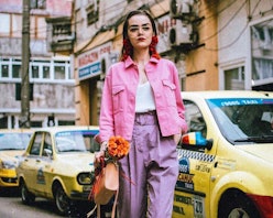 A model in a pink denim jacket and purple pants