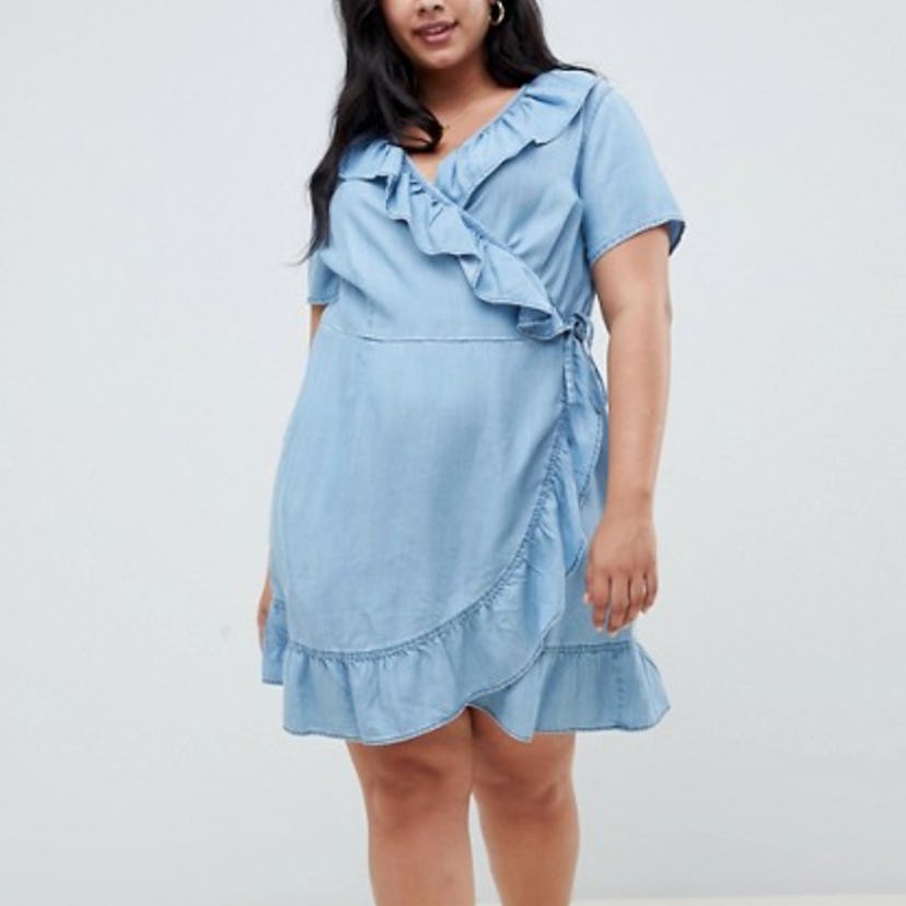 A model in curve denim wrap dress with frill detail