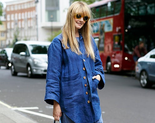 A model posing in a denim button-up and jeans
