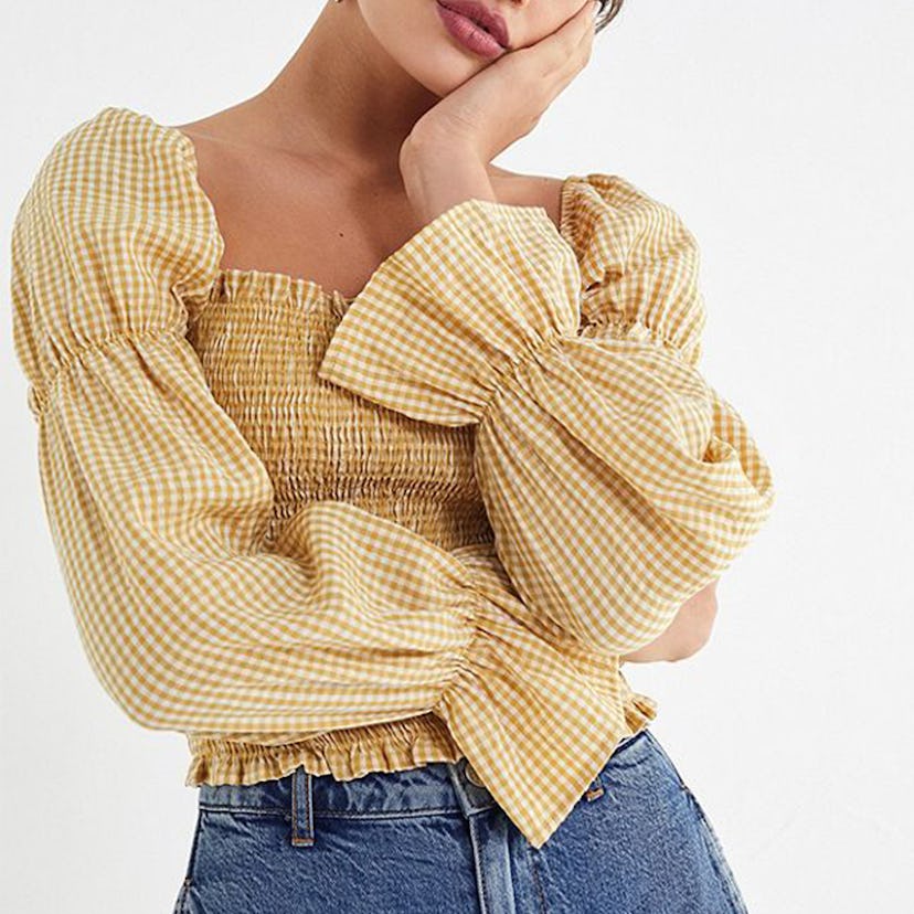 Gingham cinched-sleeve blouse worn by a female model 