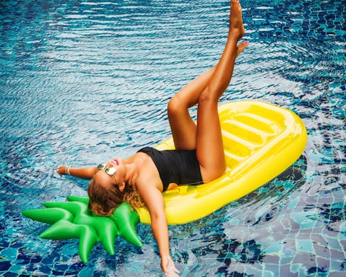 Woman lying on a pineapple-shaped pool float