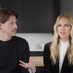Rachel Zoe, in a white shirt and a black blazer, speaking next to a man in a black shirt about her f...