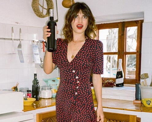 A woman wearing a black-red polka-dot dress as one of the outfit formulas French girls are obsessed ...