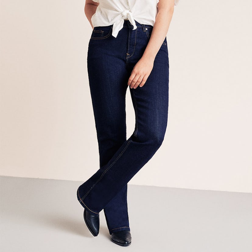 A woman standing while wearing bootcut Martha jeans