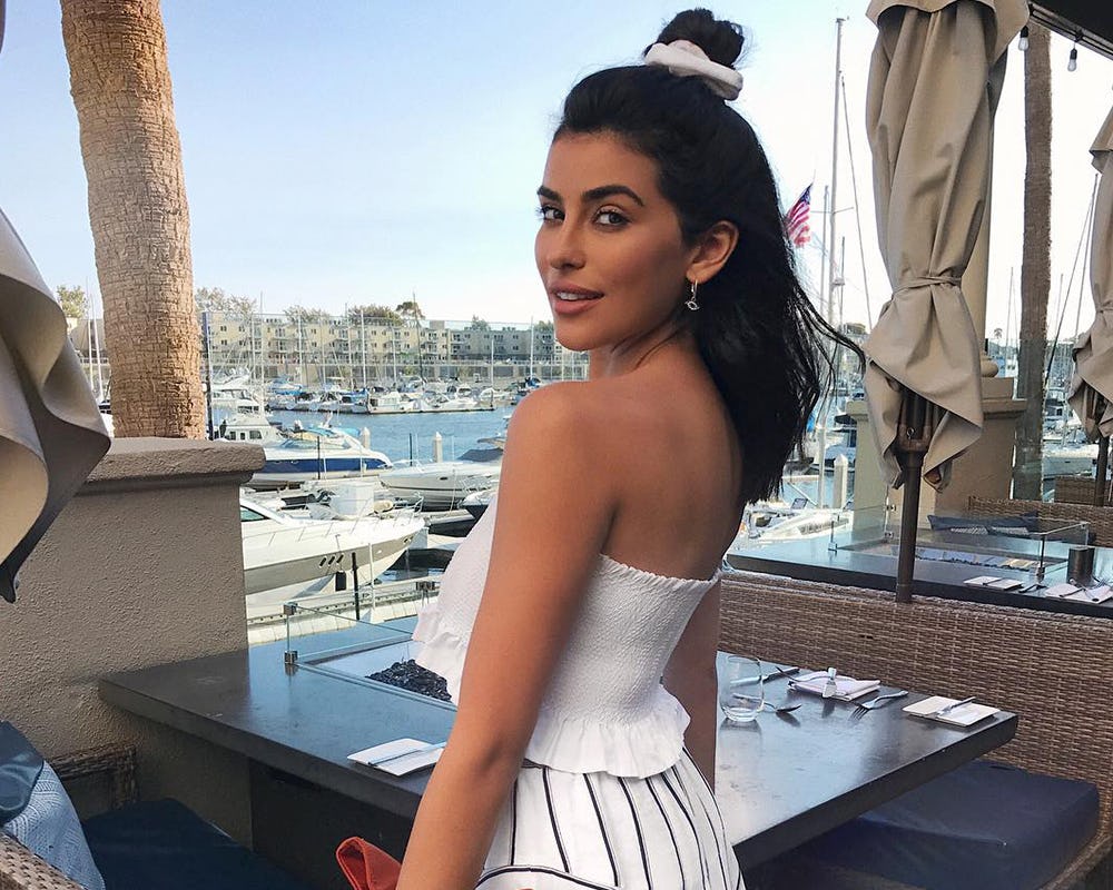 A model wearing a white summer top that looks great on everyone