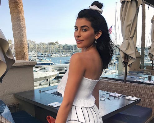 A model wearing a white summer top that looks great on everyone