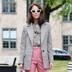 A woman posing while wearing fall trend clothes